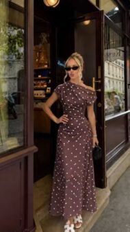Women's dress with polka dot pattern and boat neckline, with drape